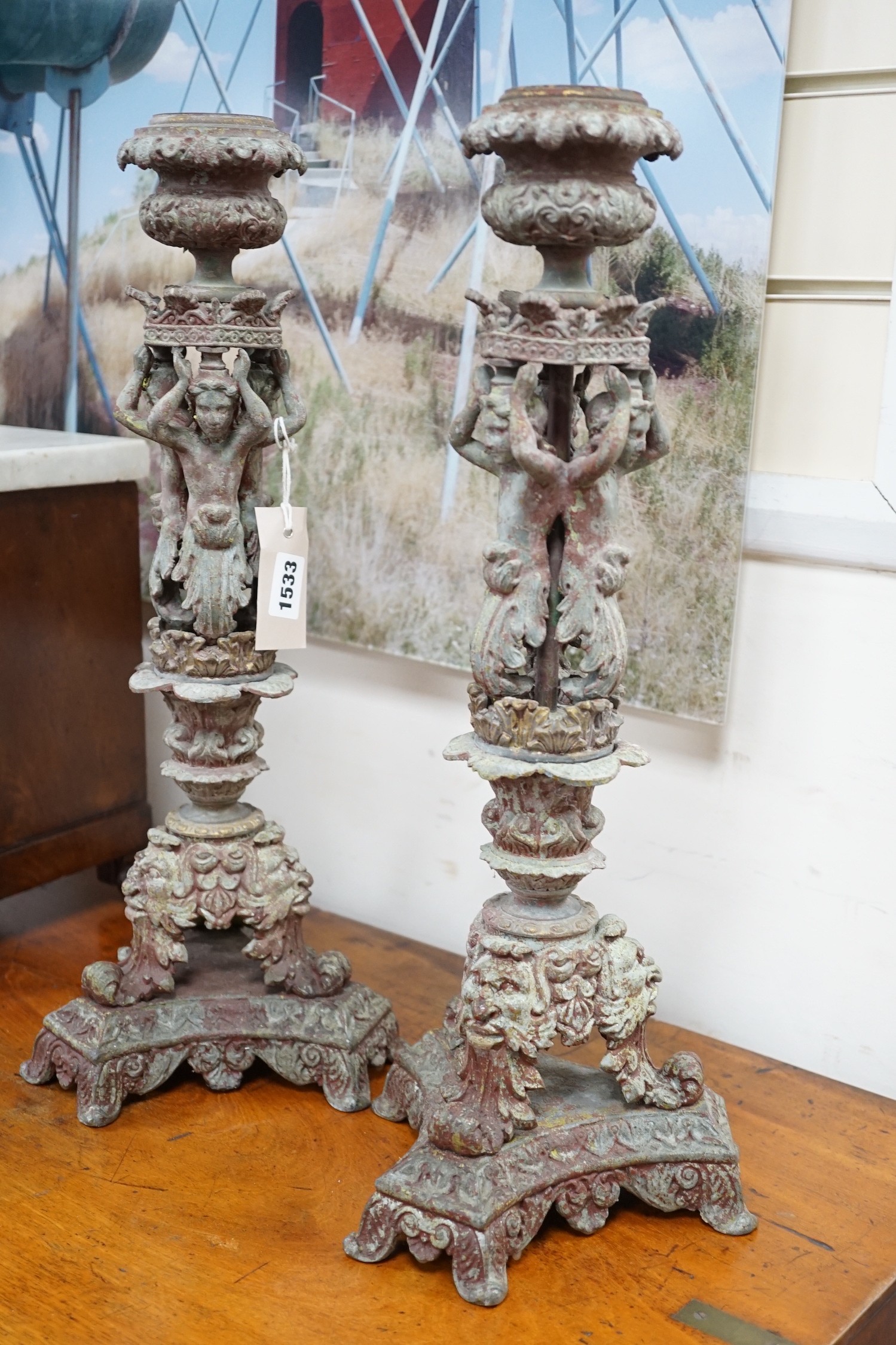 A pair French cast metal candlesticks. 47cm tall
